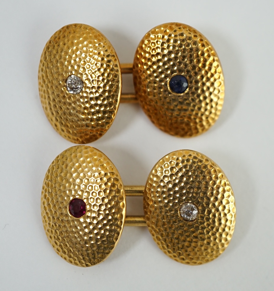 A pair of planished 18ct gold, ruby, sapphire and diamond set oval cufflinks